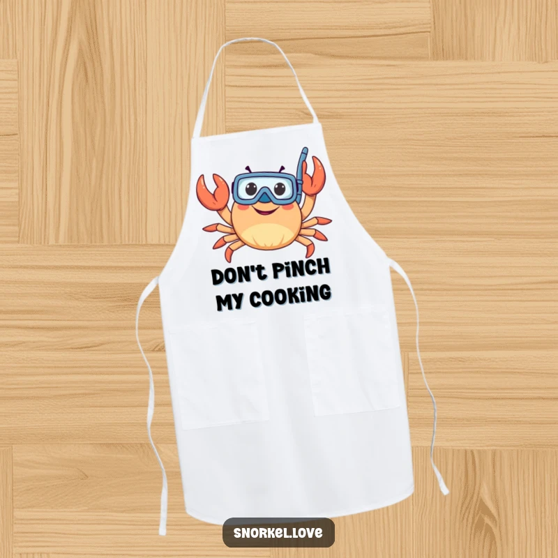 Funny crab with snorkel, waving claws, illustrated on a durable kitchen apron, bringing seaside humor to meal preparation.